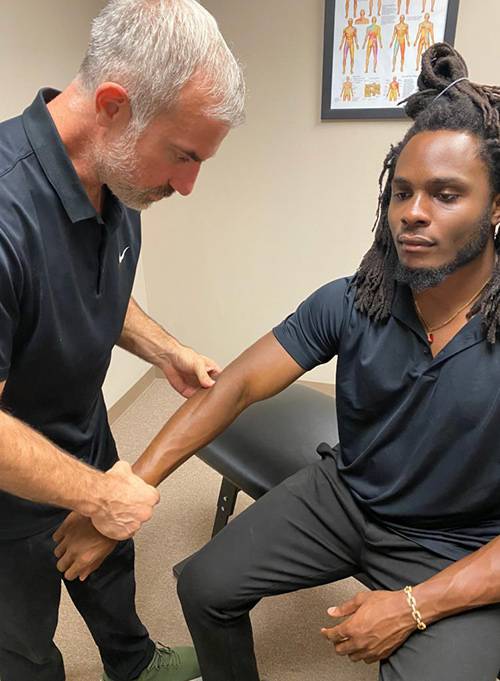 Chiropractor Addison TX David Bynum Adjusting Patient